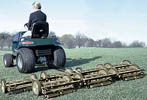 tractor pulling a gang of reel mowers