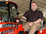 Coach Mike McCarthy on a CaseIH Farmall tractor