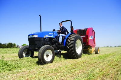 New Holland Workmaster 75 with baler