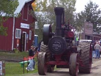 A J.I. Case steam engine comes down the main street