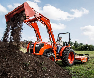 Kubota MX5800 tractor with front-end loader and rotary mower.