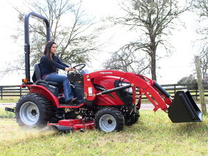 Mahindra eMax with center-mount mower deck.