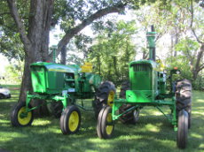 Two John Deere 4020 Hi-Crop tractors.
