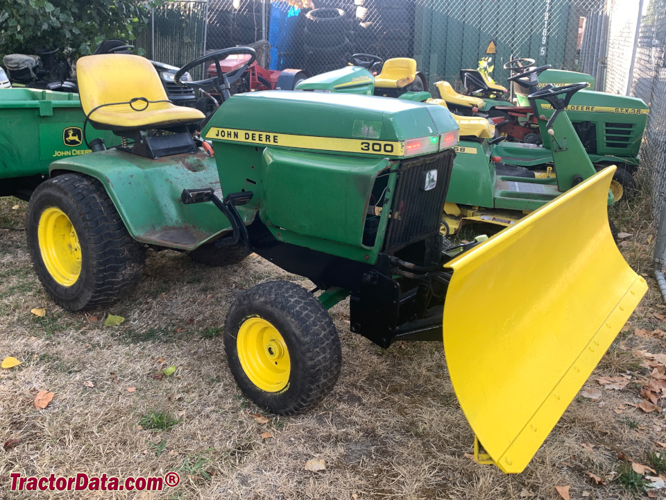 John Deere 300 garden tractor with front blade.