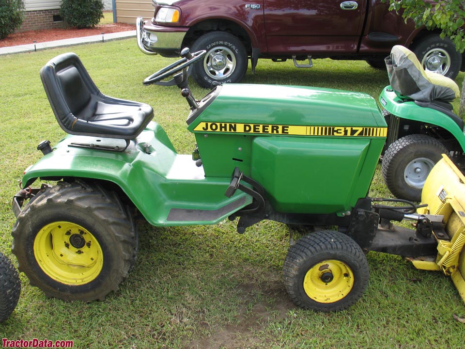 John Deere 317 with front blade and integral hitch.