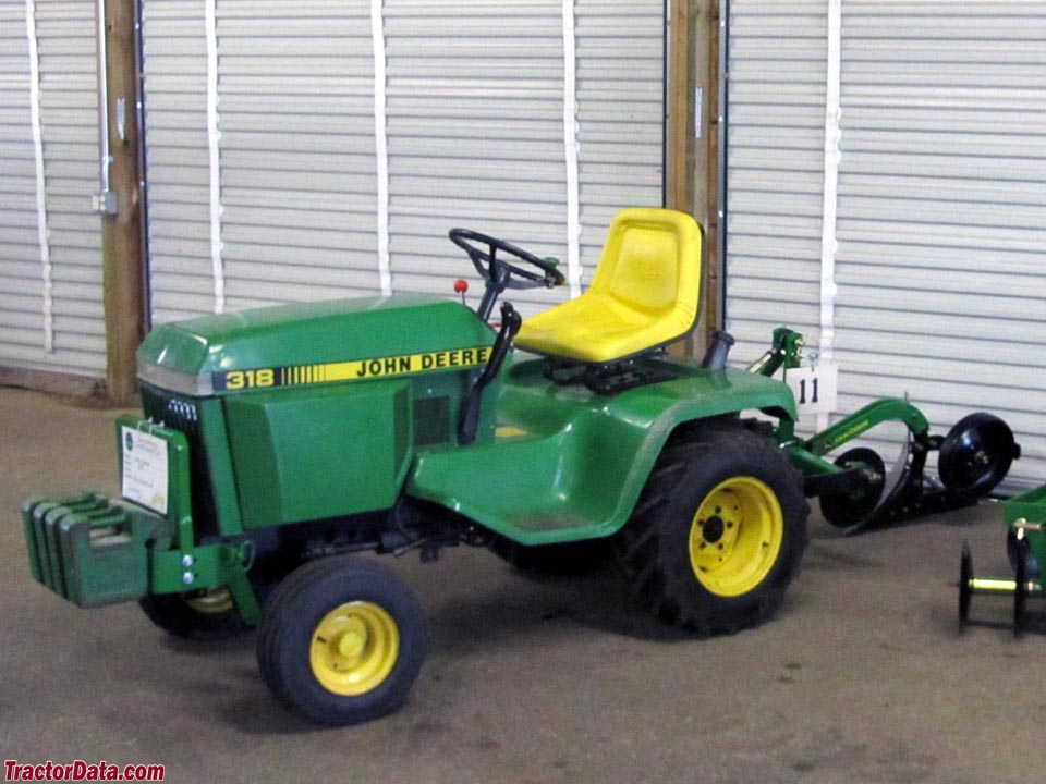 John Deere 318 with three-point plow, left side.