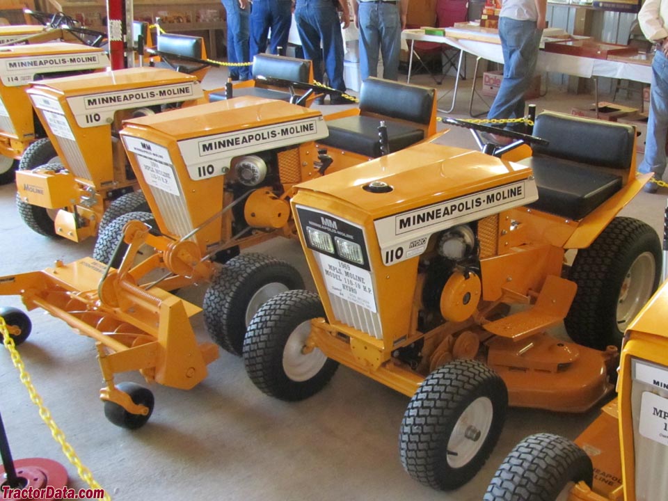 Display of three Minnapolis-Moline Town & County 110 garden tractors, with attachments.