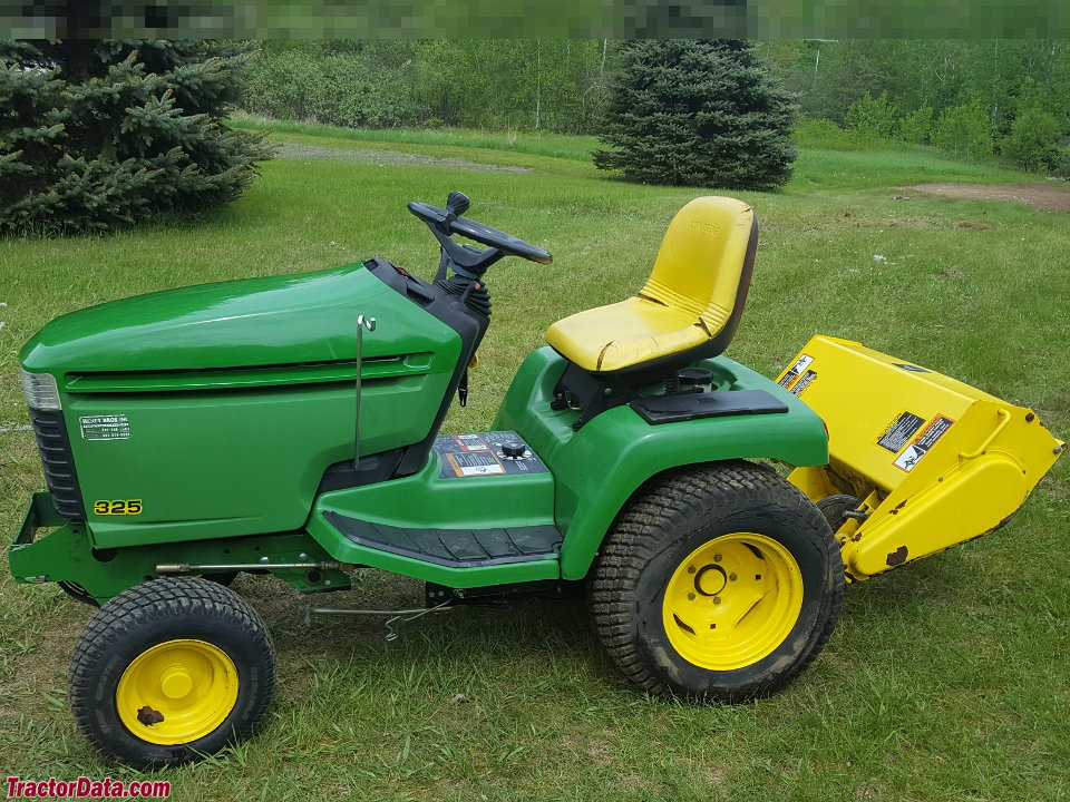 Image of John Deere 325 lawn tractor with attachments
