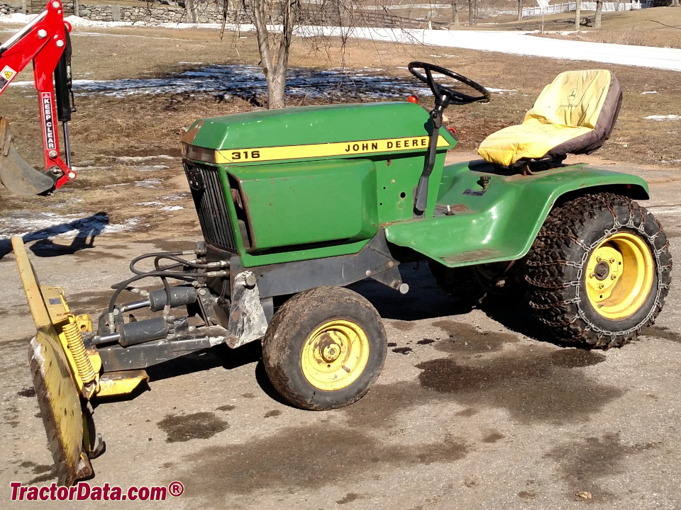 John Deere 316 with front-mount hydraulic blade.