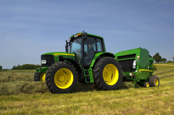 John Deere 6030 tractor with baler