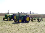 A John Deere model D and 830 diesel after plowing