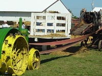 A John Deere D stands ready for belt work.