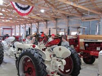 Gold and White Demonstrator tractors on display
