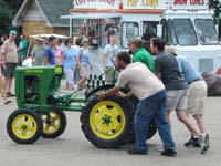 John Deere L tractor being pushed