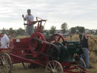 Baling hay with an International hay press powered by a McCormick engine.