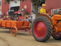 Minneapolis-Moline model Z tractor pulling a restored manure spreader.