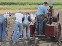 Plowing with a scale-model steam engine.