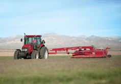Case IH Farmall 100A Series Tractor mowing hay