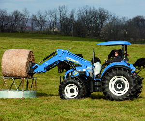 New Holland T4.105 Utility Tractor hauling hay