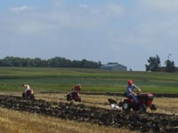 Wheel Horse garden tractors plowing in the demonstration fields.