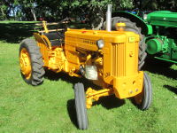 John Deere 320 in industrial yellow.