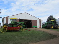 John Deere 7020 and 7520 tractors in front of the feature building.