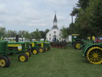 Line of John Deere tractors in front of the old Lexington Church.