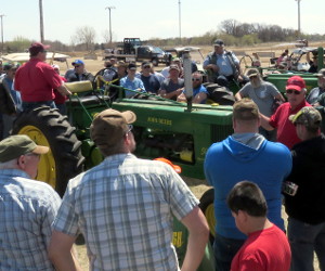 Crowd bidding on a John Deere 50 at the tractor auction.