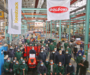 Workers pose with the first Goldoni tractor built after Keestrack purchase.