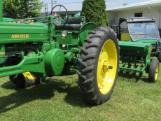 Featured machinery John Deere model B tractor with grain drill.