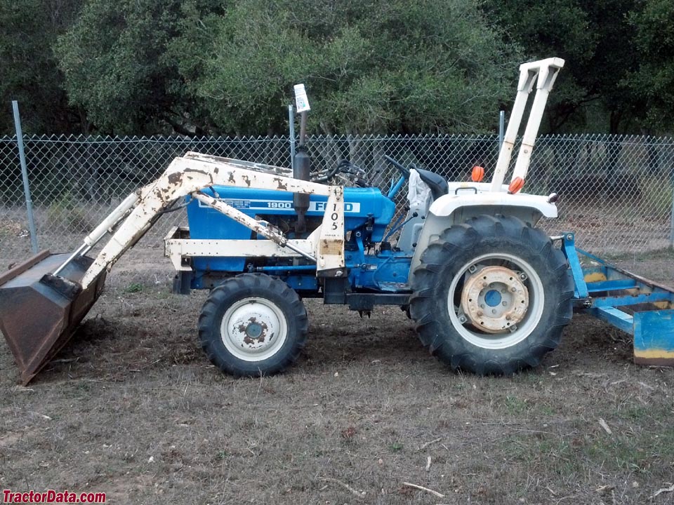 Ford 1900 with front-end loader and box blade.