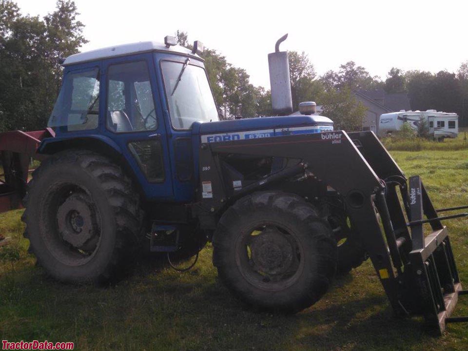 Four-wheel drive Ford 6700 with cab and Buhler model 595 loader.