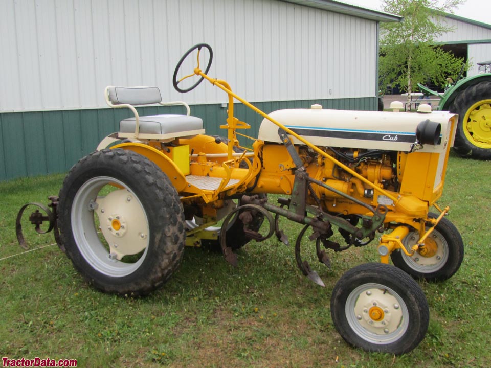 1965 yellow International Cub with mounted cultivators.