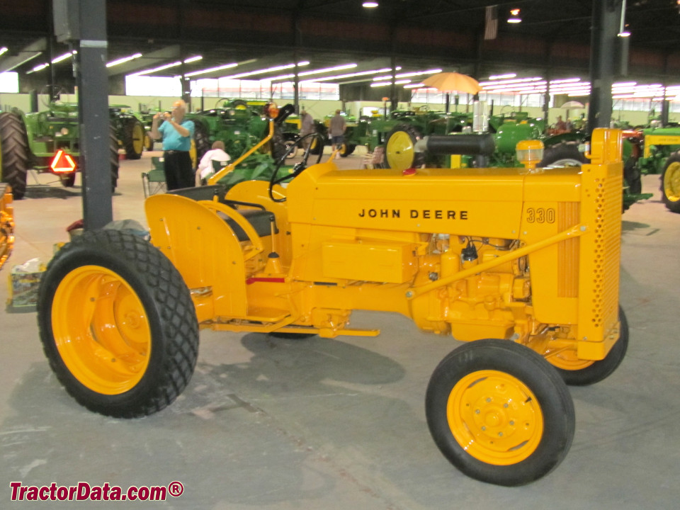 John Deere 330U in industrial yellow.