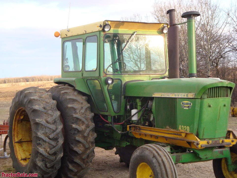 John Deere 4320 with after-market cab and dual wheels.