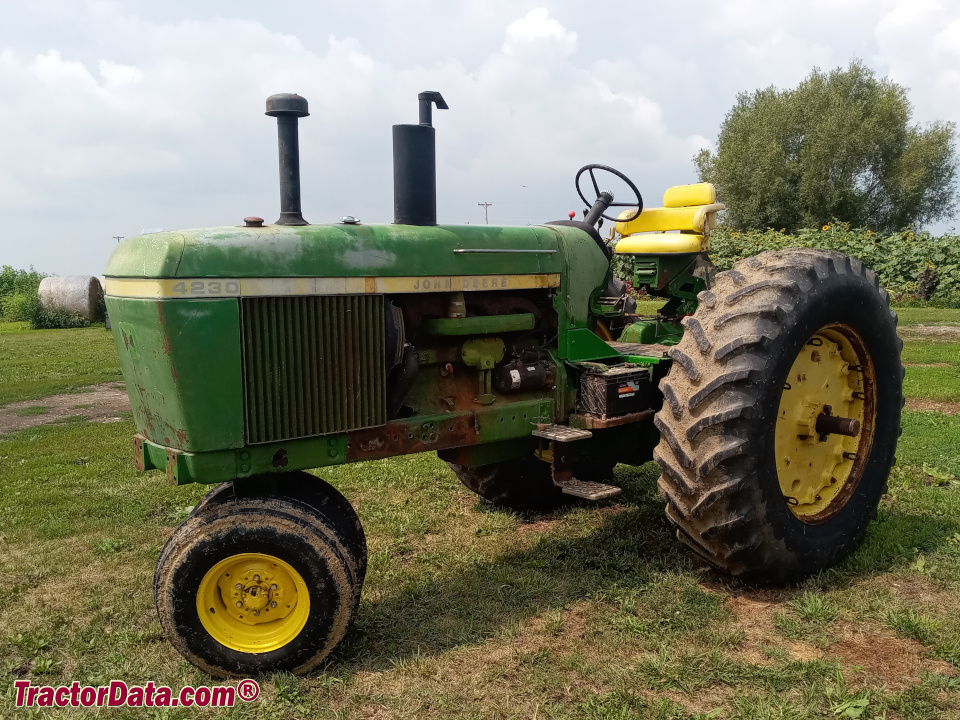 Open station John Deere 4230 with tricycle front, left side.