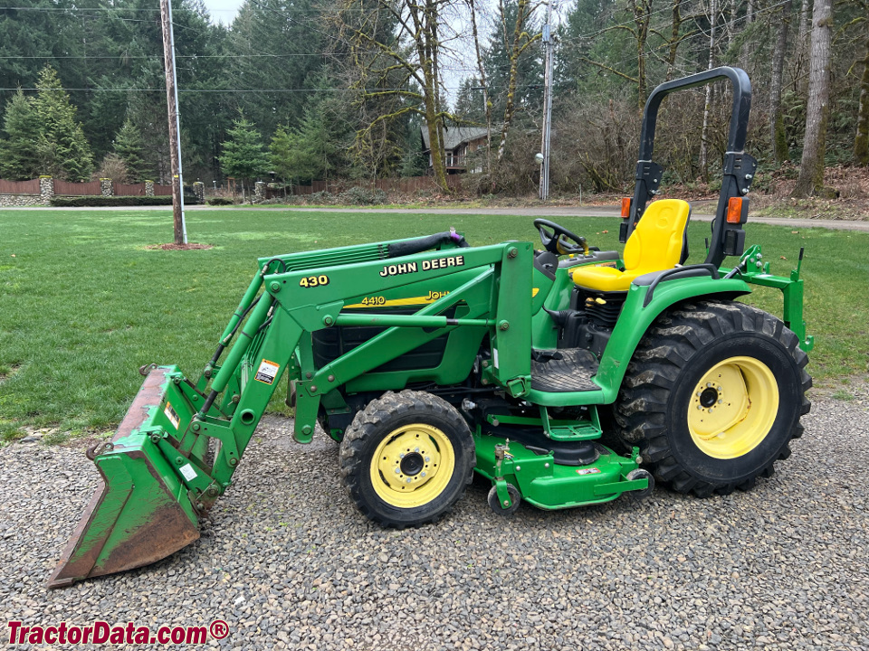 John Deere 4410 with 430 front-end loader and mid-mount mower, left side.