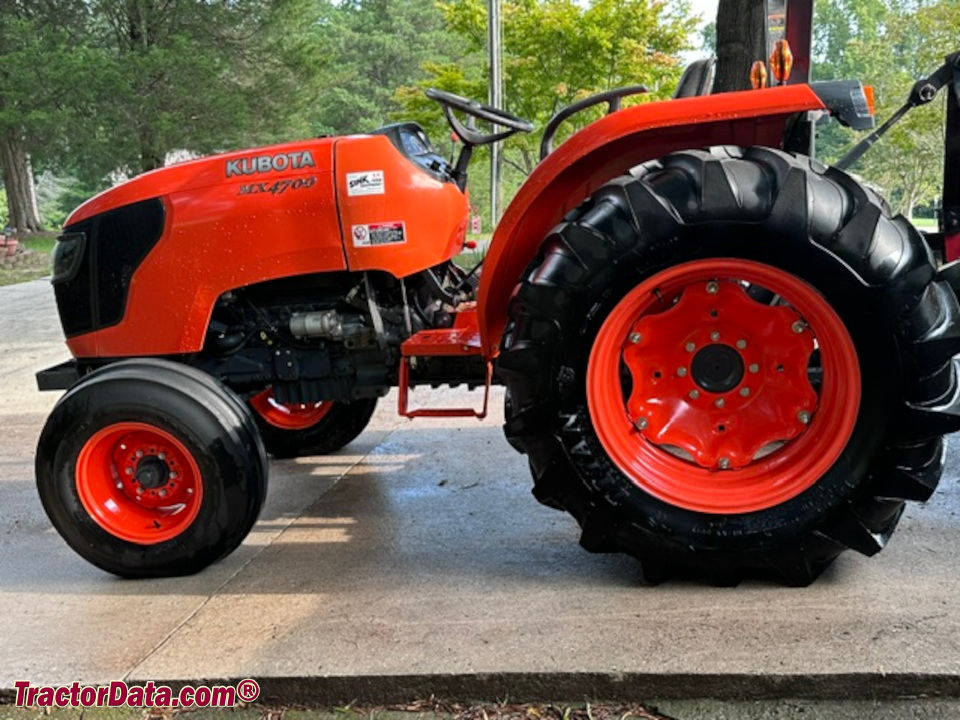 Kubota MX4700 compact utility tractor, left side.