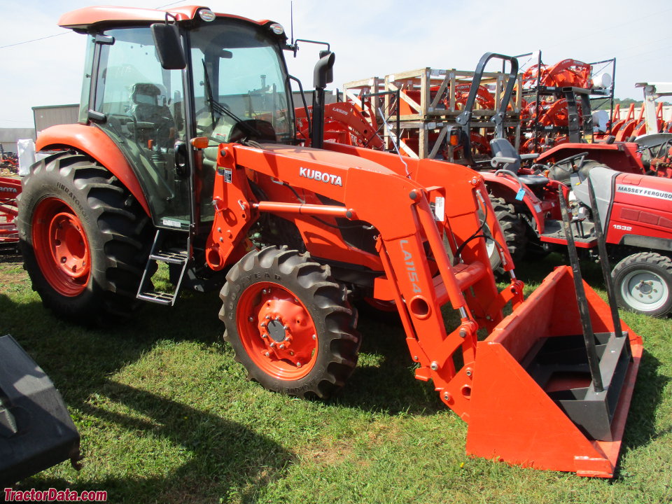 Kubota M7060 with cab and loader, right side.