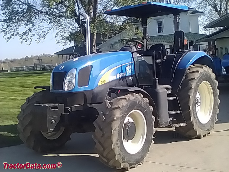 New Holland TS125A utility tractor with ROPS.